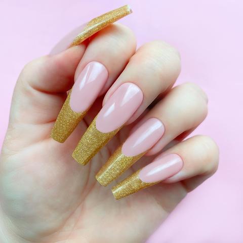 gold nail design with french tips and glitter