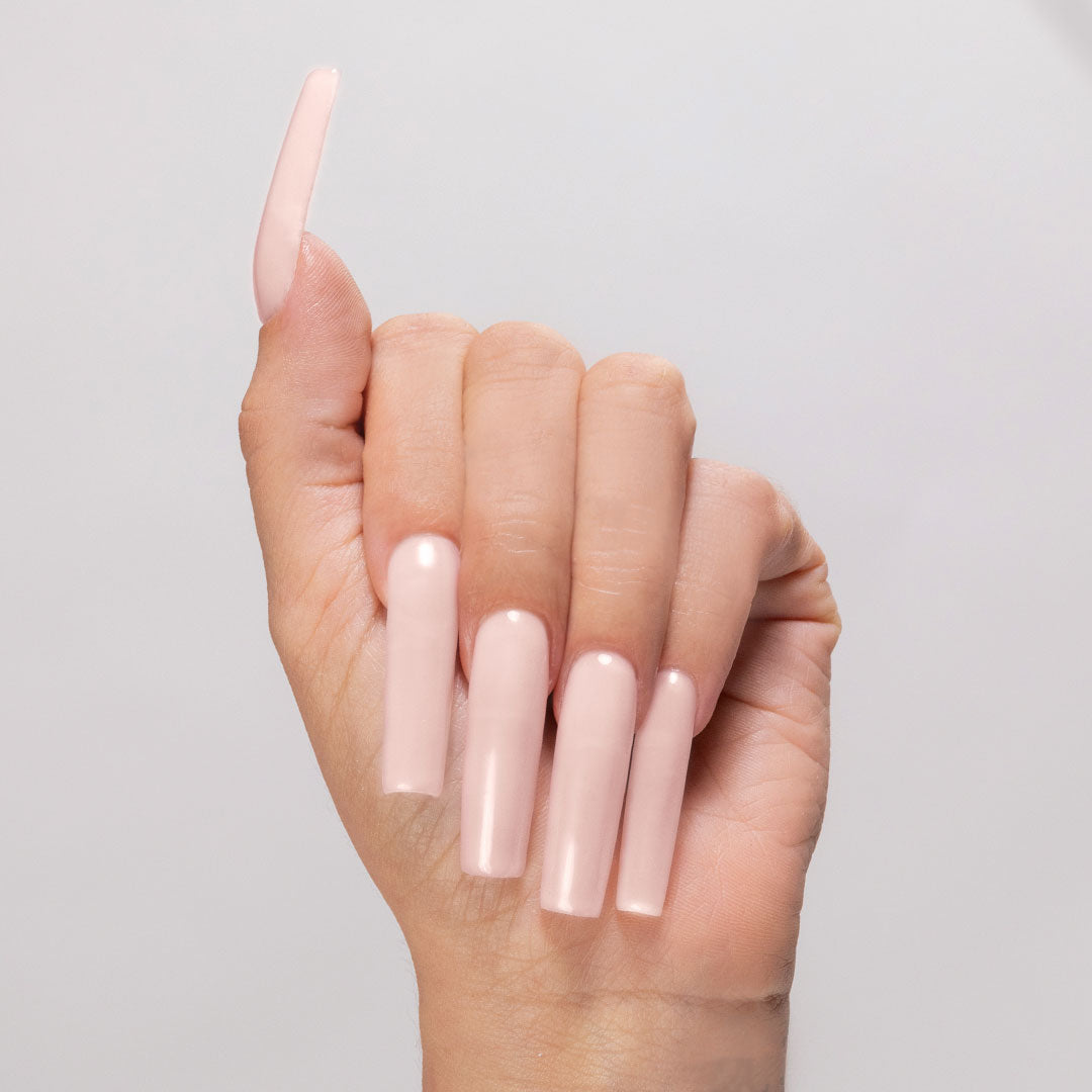 Cream Puff cover acrylic powder applied on light-skinned hand