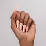 Kiara Sky Autumn Blonde cover acrylic powder applied to a dark-skinned hand