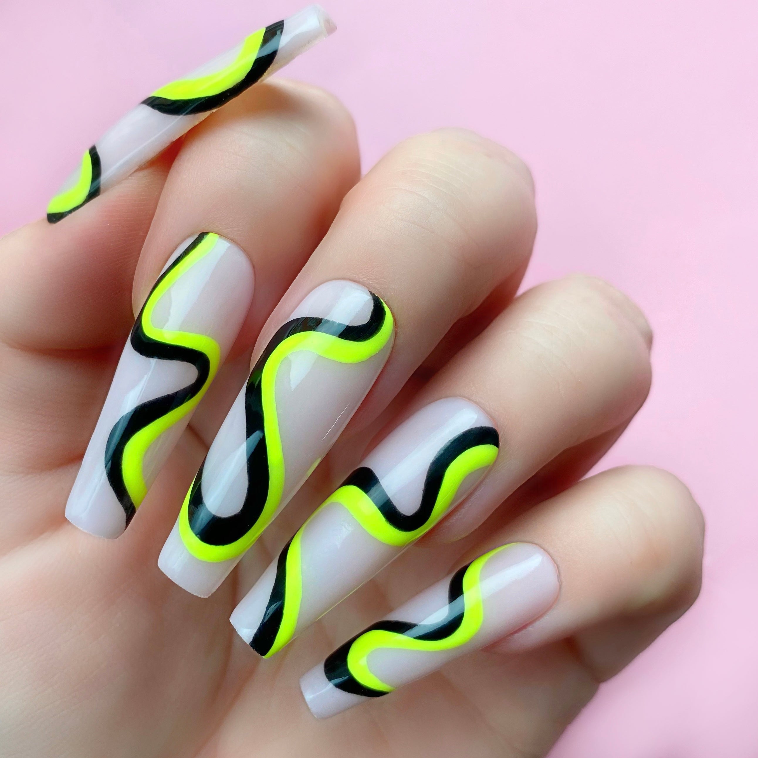 Negative Space gel art applied to nail extensions with swirly design